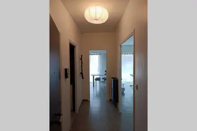a hallway with a light on the ceiling at Grand Studio avec Coin Nuit et Parking in Saint-Laurent-du-Var
