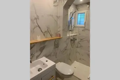 a bathroom with a toilet and a sink and a shower at Appartement neuf 4-6 personnes en bord de Mer in Nice