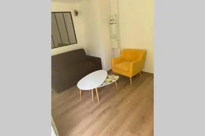 a living room with a couch and a chair at Appartement neuf 4-6 personnes en bord de Mer in Nice
