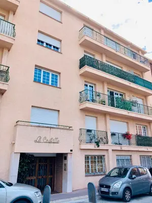 a building with cars parked in front of it at Résidence Le Castille in Nice