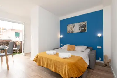 a bedroom with a bed with a blue wall at Maison Bianchi - Herold in Nice