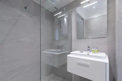 a white bathroom with a sink and a shower at Maison Bianchi - Herold in Nice