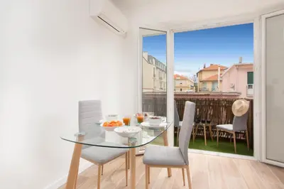 a dining room with a glass table and chairs at Maison Bianchi - Herold in Nice
