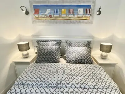 a bedroom with a bed with two lamps and a painting at Central Modern Flat Lamartine in Nice