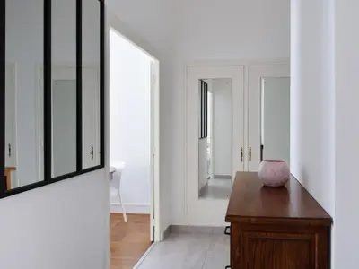 a room with a mirror and a wooden table at Le Philanthrope - Balcon Wifi Climatisation in Nice