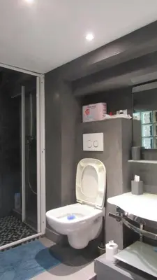 a bathroom with a toilet and a shower and a sink at Charming and Modern Cave in the Heart of the Port in Nice