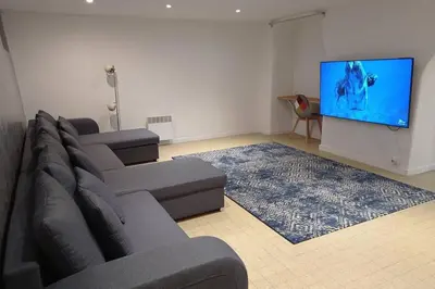 a living room with a couch and a flat screen tv at Charming and Modern Cave in the Heart of the Port in Nice