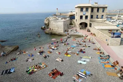 a group of people on a beach near the water at Charming and Modern Cave in the Heart of the Port in Nice