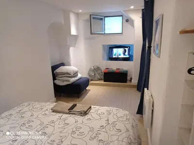 a bedroom with a bed and a tv in a room at Charming and Modern Cave in the Heart of the Port in Nice