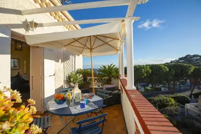 a patio with a table and an umbrella on a balcony at Villa MonTLilin - Happy Rentals in Villefranche-sur-Mer