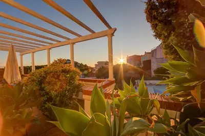 a view of a patio with plants and an umbrella at Villa MonTLilin - Happy Rentals in Villefranche-sur-Mer