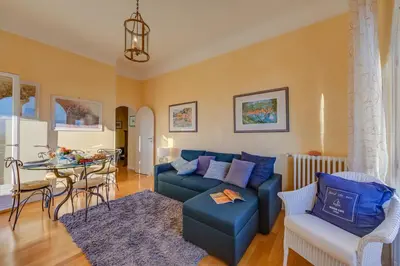 a living room with a blue couch and a table at Villa MonTLilin - Happy Rentals in Villefranche-sur-Mer