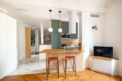 a kitchen with a counter and two stools at La Maioneta Vieux-Nice in Nice