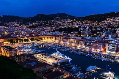 a harbor at night with boats in the water at Studio neuf 25 m2, terrasse 35 m2 proche port Nice, Centre ville in Nice