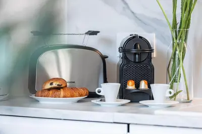 a loaf of bread on a table next to a toaster at FEEL HOME - ALPHONSE KARR in Nice