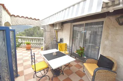 a poster for la plana with a picture of a village at Studio climatisé et sa terrasse privée en villa in La Trinité