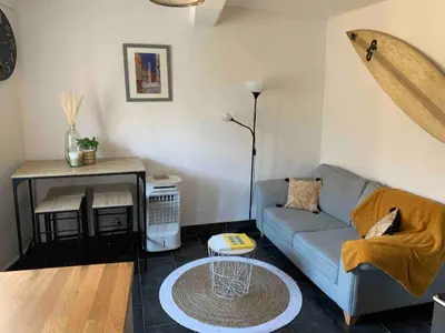 a living room with a couch and a table at Cosy sweet space in paradise - 5min from the beach in Nice