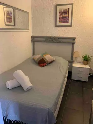 a bedroom with a bed with two pillows on it at Cosy sweet space in paradise - 5min from the beach in Nice