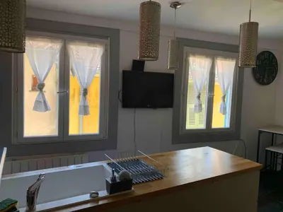 a kitchen with two windows and a bath tub at Cosy sweet space in paradise - 5min from the beach in Nice
