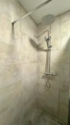 a shower with a shower head in a bathroom at Studio Carré d'Or in Nice