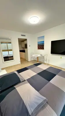 a bedroom with a large bed with a flat screen tv at Studio Carré d'Or in Nice