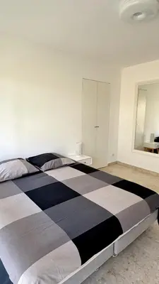 a large black and white bed in a bedroom at Studio Carré d'Or in Nice