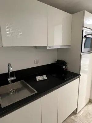 a kitchen with white cabinets and a sink at Studio Carré d'Or in Nice