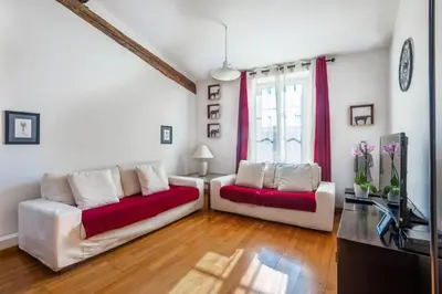 a living room with two couches and a tv at Samourai Massena Lodge -1 min from the sea in Nice