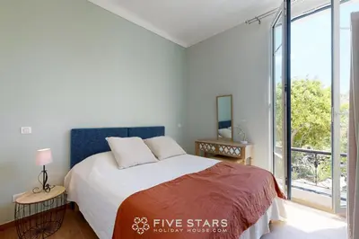 a bedroom with a bed and a large window at Villa Capriciosa - Five Stars Holiday House in Beaulieu-sur-Mer