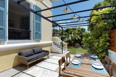 a patio with a table and chairs and a pergola at Villa Capriciosa - Five Stars Holiday House in Beaulieu-sur-Mer