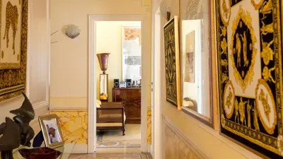 a hallway with paintings on the walls and a hallway with at La NONETE in Villefranche-sur-Mer