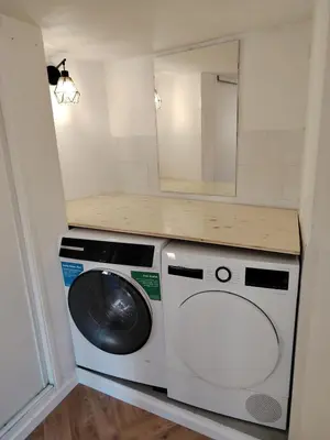 a laundry room with a washing machine and a mirror at 35m2, luminous loft close to the beach in Villefranche-sur-Mer