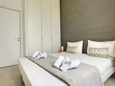 a bedroom with two beds with white shoes on them at Nestor&Jeeves - ALBERT 1ER DESIGN - Hyper center - Very close sea and pedestrian zone in Nice