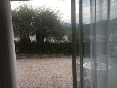 a sliding glass door with a view of a yard at Loft 1 in La Trinité