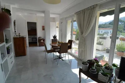 a kitchen and dining room with a table and chairs at PHOENIX - Appartement 4 personnes avec superbe terrasse, clim et parking le port de Nice in Nice