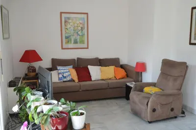 a living room with a couch and a chair at PHOENIX - Appartement 4 personnes avec superbe terrasse, clim et parking le port de Nice in Nice