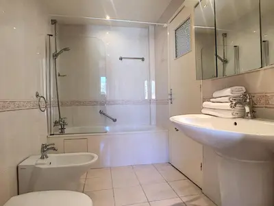 a bathroom with a sink and a toilet and a shower at Nestor&Jeeves - OCEAN PROMENADE - Terrace with sea view - Spacious in Nice