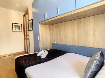 a bedroom with a bed with two white towels on it at Nestor&Jeeves - OCEAN PROMENADE - Terrace with sea view - Spacious in Nice