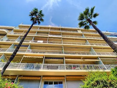 two palm trees in front of a building at Nestor&Jeeves - OCEAN PROMENADE - Terrace with sea view - Spacious in Nice
