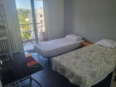 two beds in a small room with a balcony at NEW CHEAP PRIVATE ROOM, KITCHEN , OVERWIEUW sea,TRAM on spot, 12 minutes from nice train station with tram , beach in 17 min tram , CHAMBRE PRIVÉE pas cher, cuisine équipée , tram sur place, APERÇU mer, 12 min de la gare de Nice avec le tram, 17 min plage in Nice