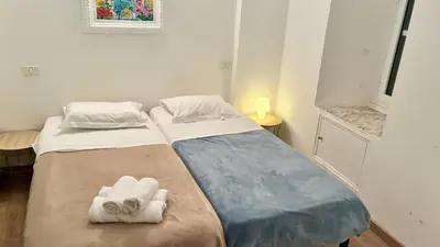 two beds in a small room with towels on them at ApartHotel Riviera - JEAN JAURES 1 - Vieille Ville - Appartement de 3 pieces AC - 100m de la plage in Nice