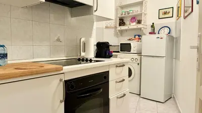 a kitchen with a stove and a refrigerator at ApartHotel Riviera - JEAN JAURES 1 - Vieille Ville - Appartement de 3 pieces AC - 100m de la plage in Nice