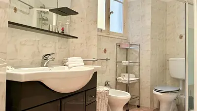 a white bathroom with a sink and a toilet at ApartHotel Riviera - JEAN JAURES 1 - Vieille Ville - Appartement de 3 pieces AC - 100m de la plage in Nice