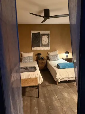 a bedroom with two beds and a ceiling fan at Villa de luxe piscine vue mer in Nice