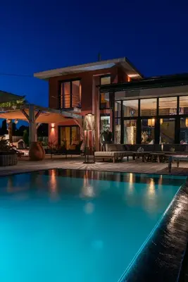 a swimming pool in front of a house at night at Villa de luxe piscine vue mer in Nice