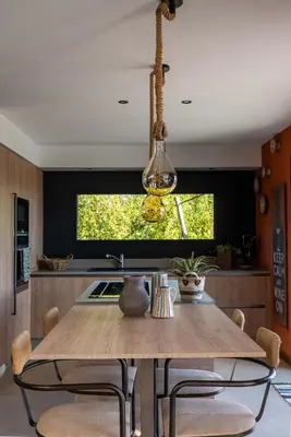 a dining room with a wooden table and chairs at Villa de luxe piscine vue mer in Nice