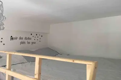 a bedroom with a bed with a sign on the wall at Superbe studio sur Nice in Nice
