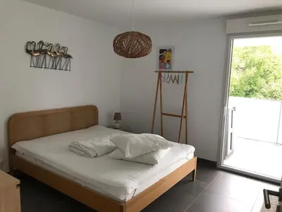 a bedroom with a bed with white sheets and a window at Appartement à Nice in Nice