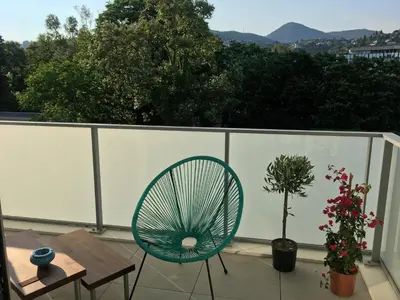 a green chair sitting on a balcony with a table at Appartement à Nice in Nice