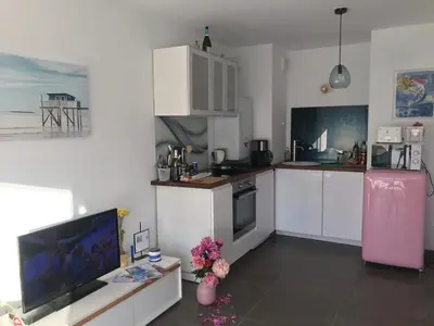 a kitchen with white cabinets and a pink refrigerator at Appartement à Nice in Nice